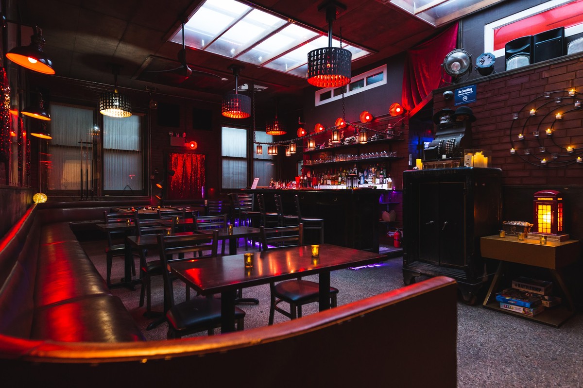 a dimly lit bar with a red light