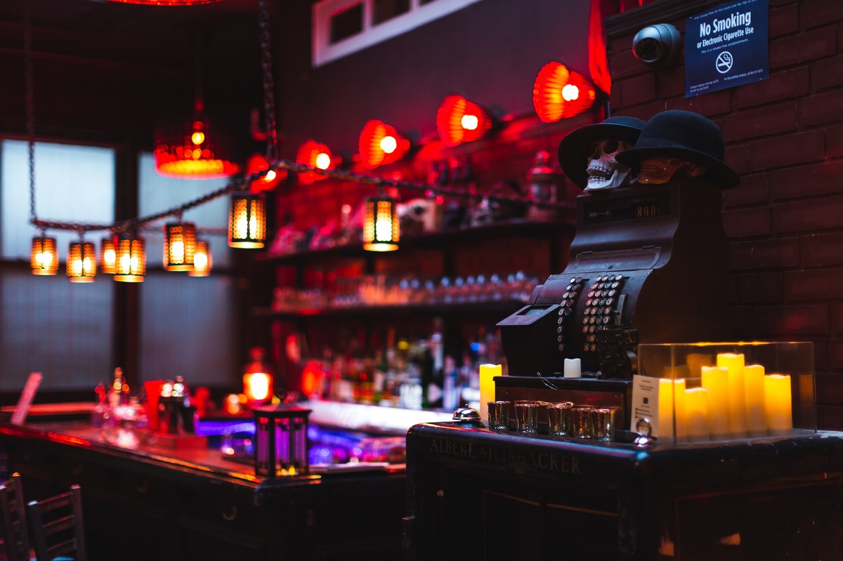 a dimly lit bar with candles on the counter