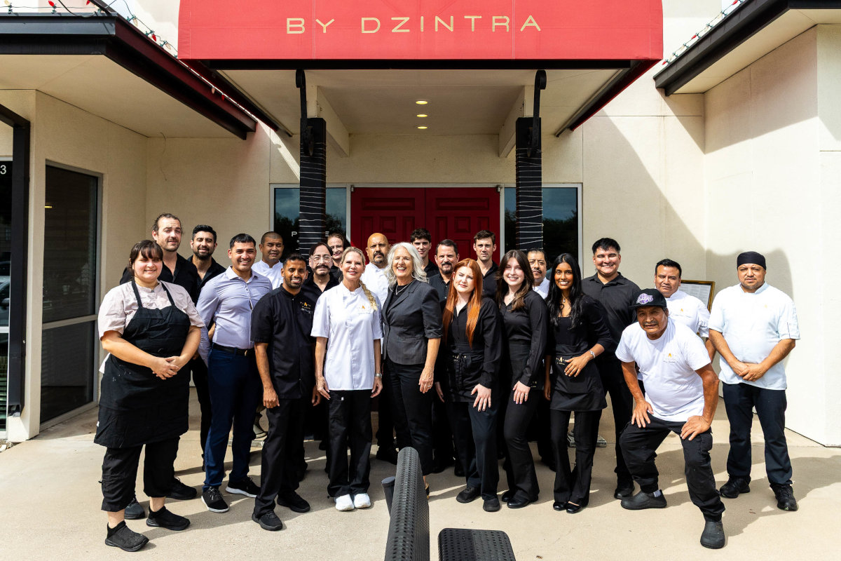The entire “Plate by Dzintra” team stands in front of the restaurant