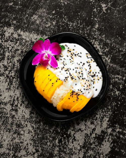 a plate of food with a flower on top at Daughter Thai Kitchen & Bar