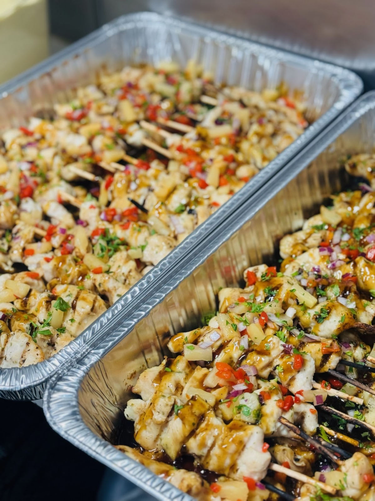 Trays filled with grilled chicken skewers