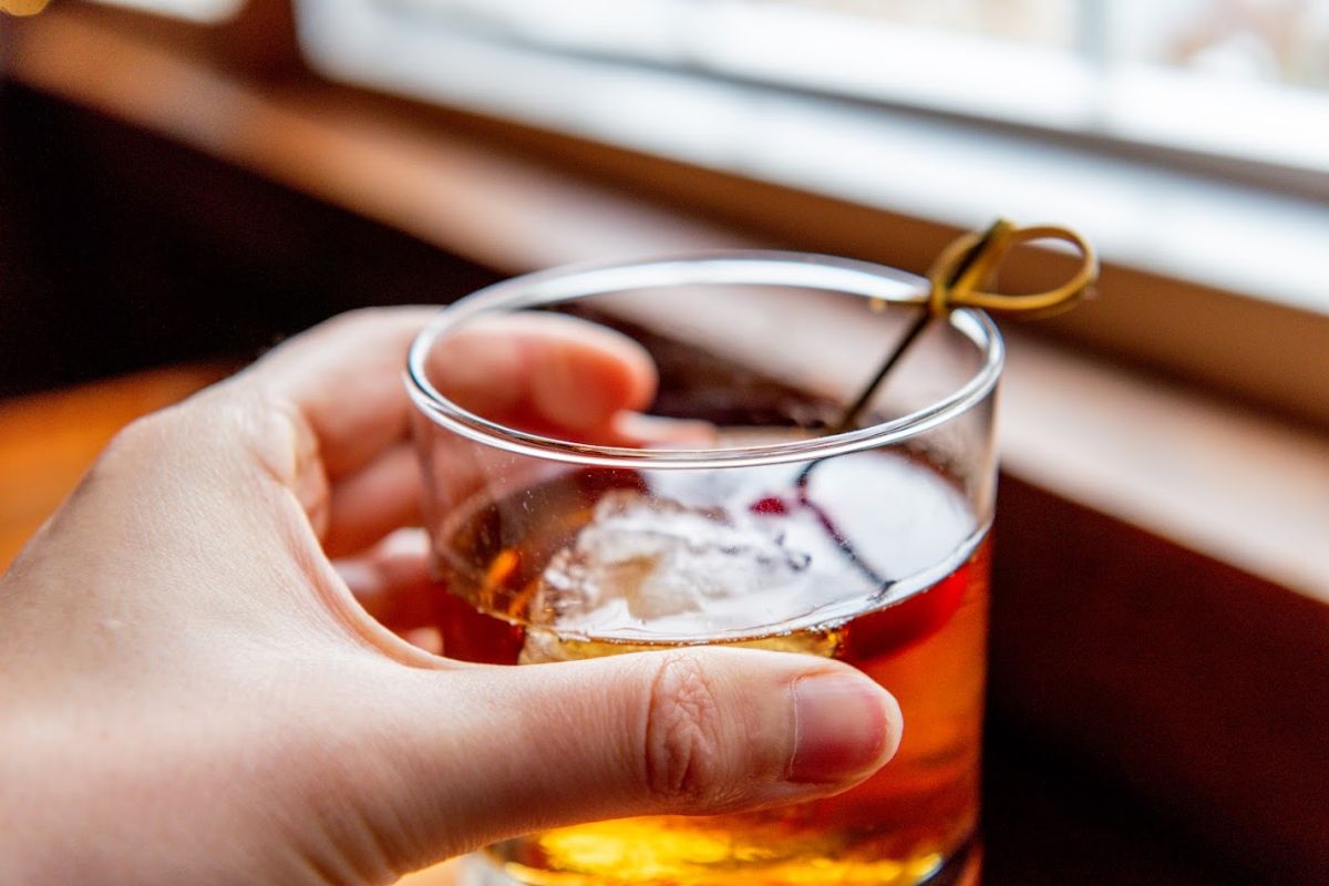 Close-up shot of hand-held Maple Old Fashioned