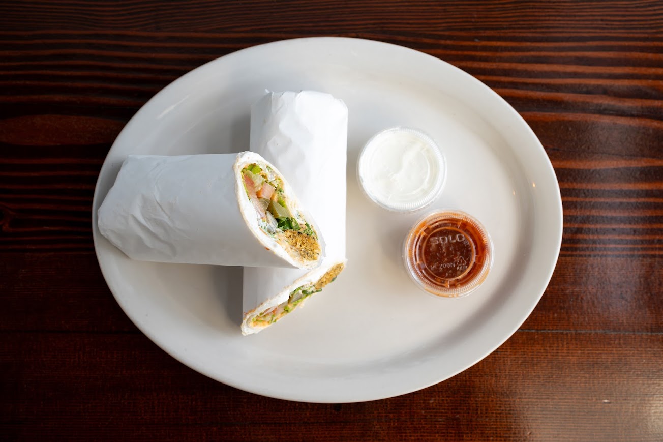 Falafel with cilantro, tomato, onion, lettuce, pickles, and yogurt