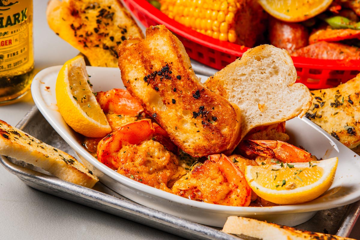 Stuffed shrimp served with toast bread and lemon