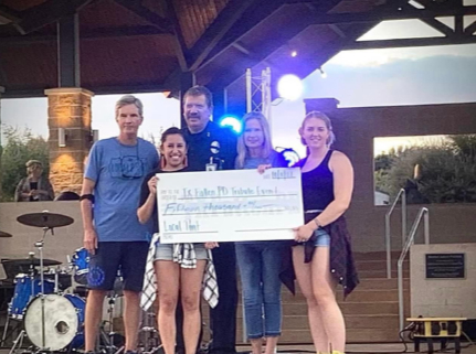 Group holding a donation check at the Local Pint TPCA fundraiser event