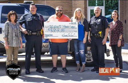 Local Pint staff presenting a donation check with police officers