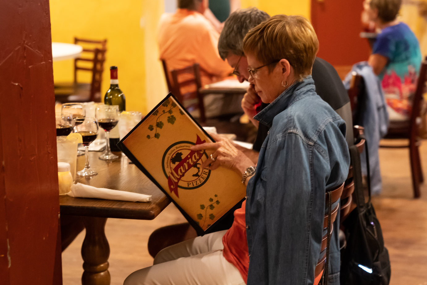 Interior, a guest reading the menu at table