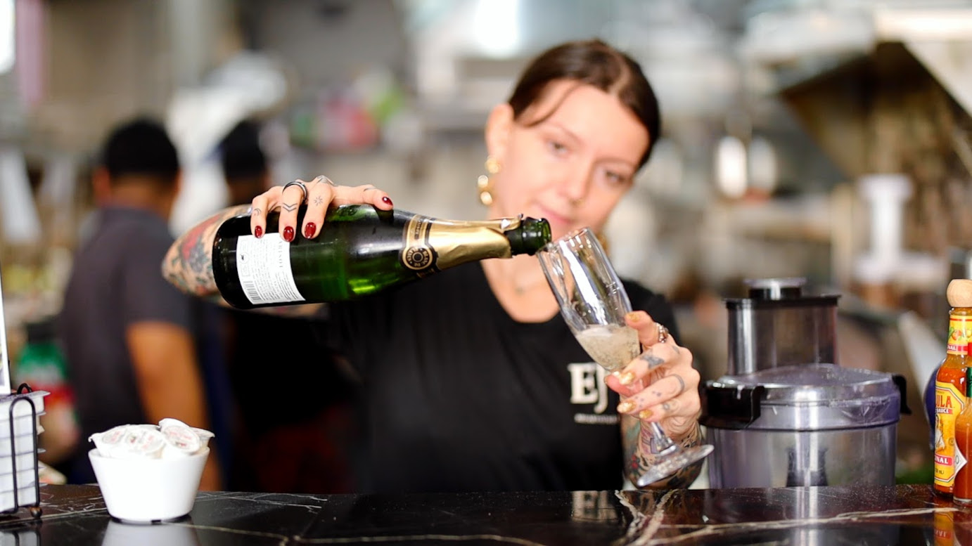 Bartender  pouring a glass of champagne