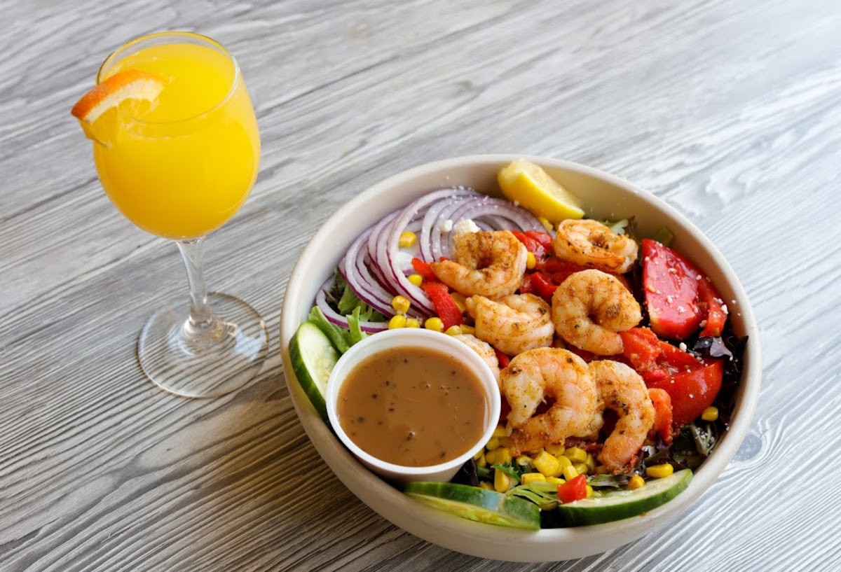 Shrimp salad with a glass of orange juice