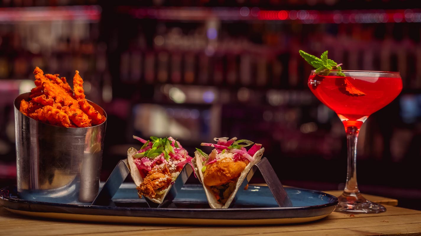 Fish tacos with sweet potato fries and mixed drink