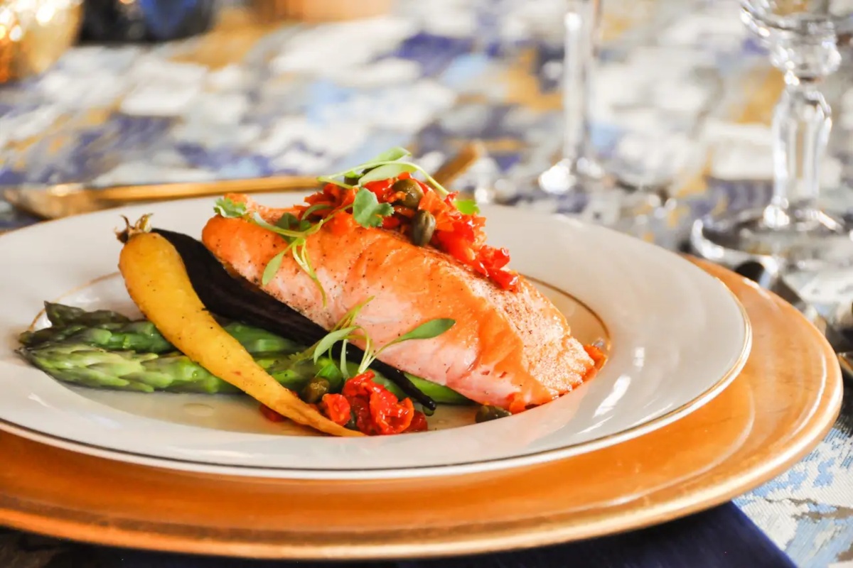 a plate with salmon and vegetables on it.