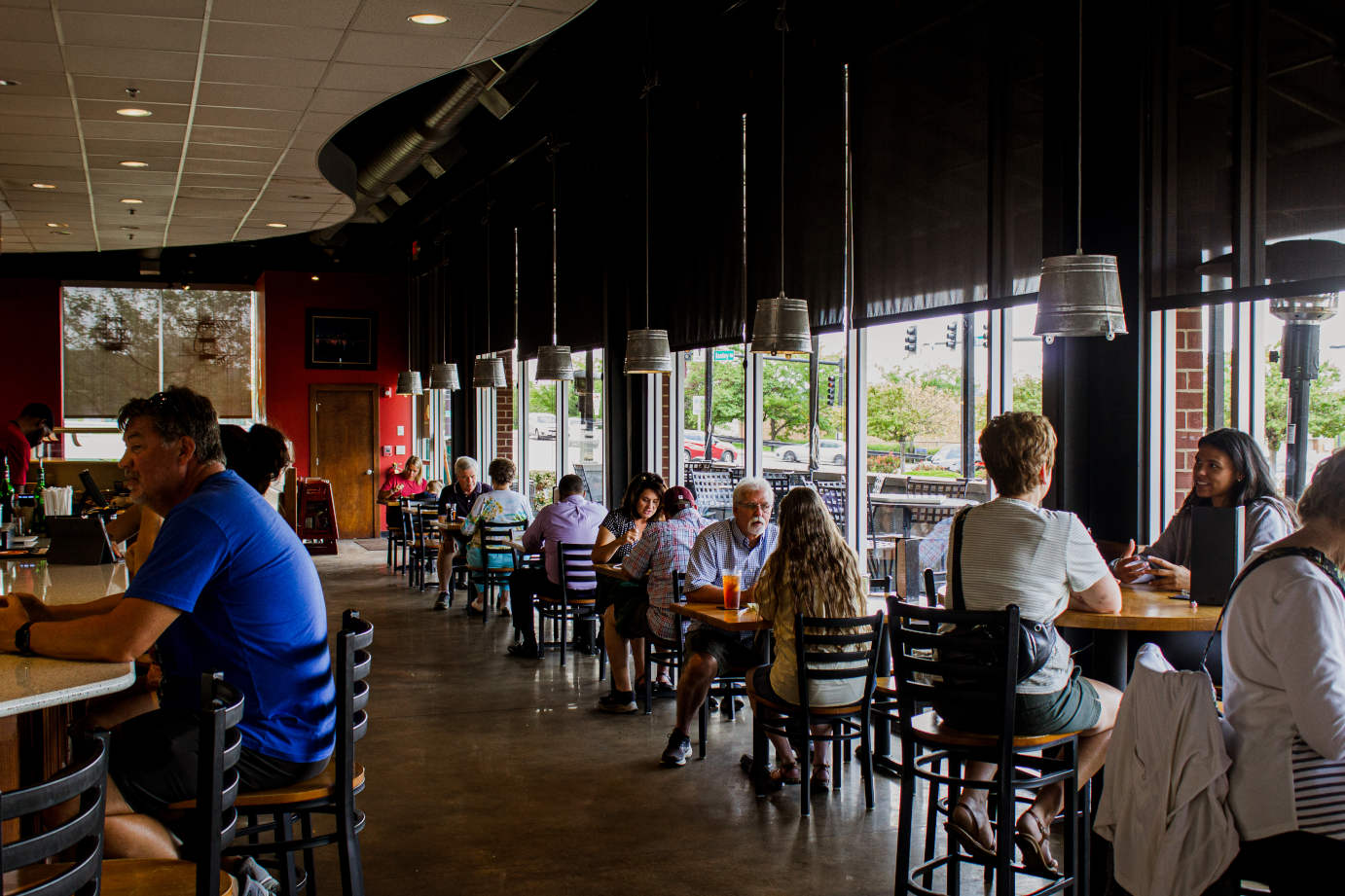 Interior, guests sitting at bar counter and tables