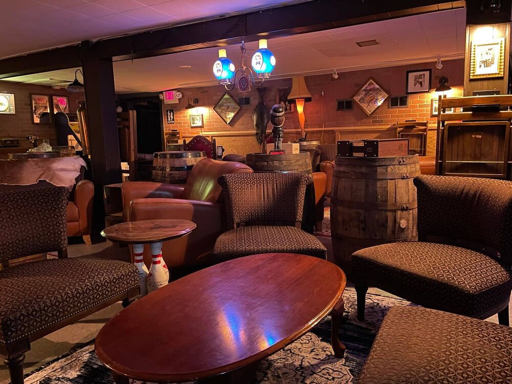 A room with couches, chairs and a table.