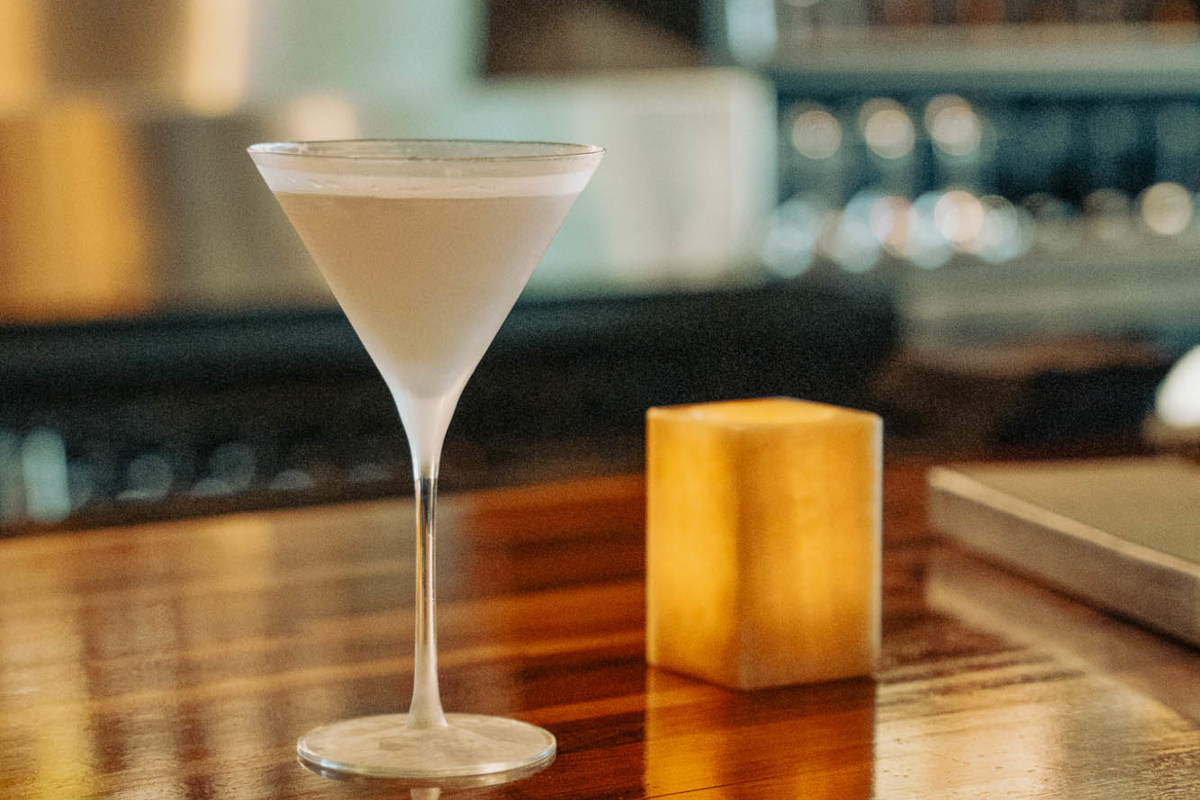 A white cocktail on a wooden table