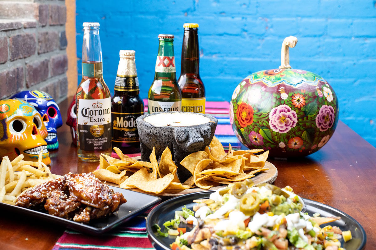  Beer Chow table with different types of dishes and Mexican beer