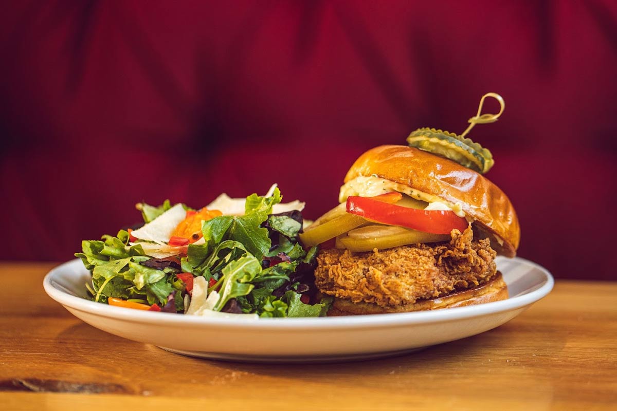 Fried chicken sandwich, served with mixed greens salad