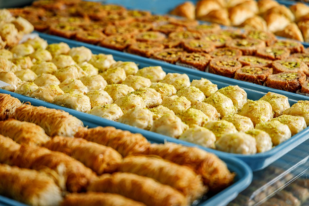 Trays of assorted Middle Eastern pastries and baklava with pistachio