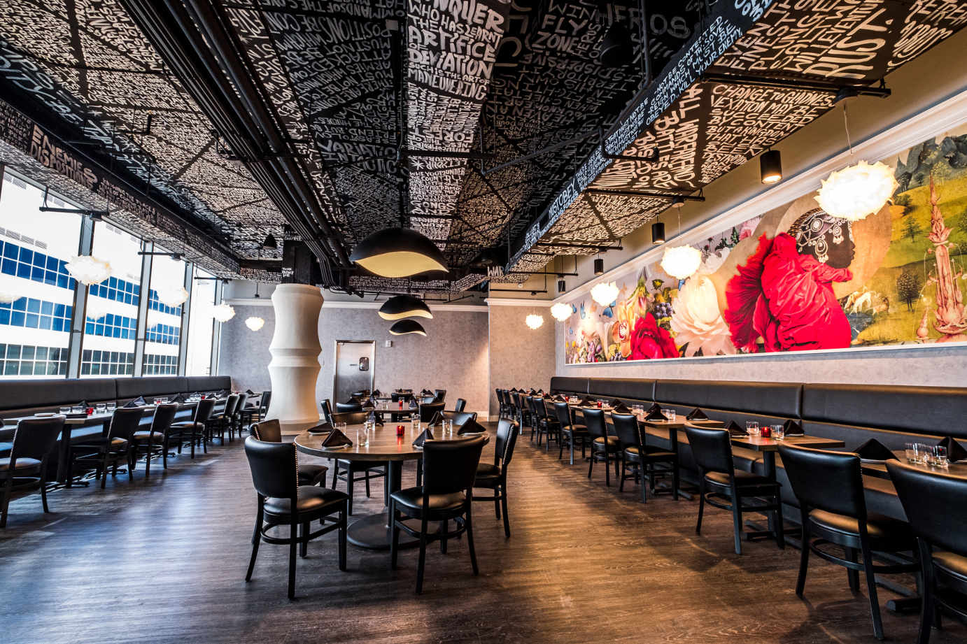 Interior, set dining tables and seating, decorated wall and ceiling