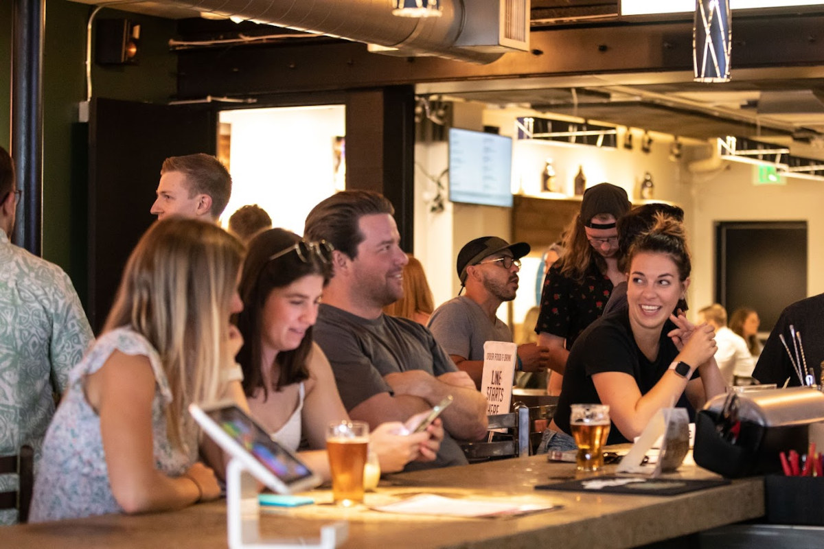 Interior, people hang out at the bar