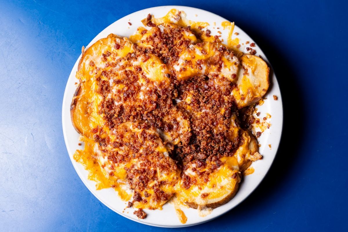 Skin-on potato slices with cheese and bacon bits