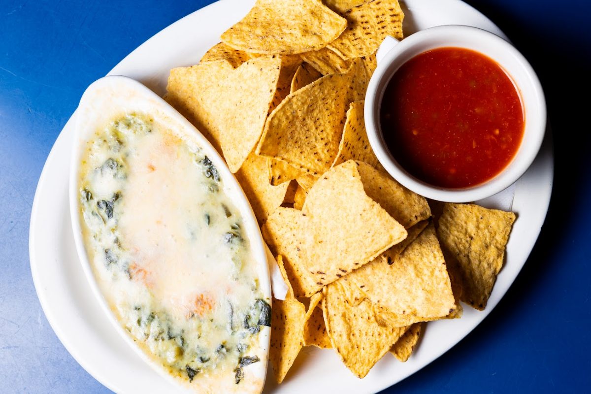Dip topped with melted parmesan served with tortilla chips and picante.