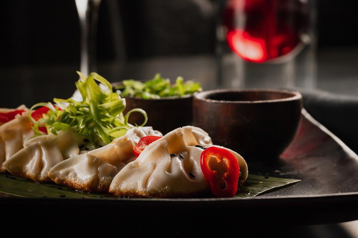Steamed dumplings served with dipping sauce