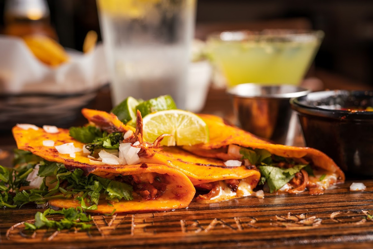 Angus steak tacos served with onions