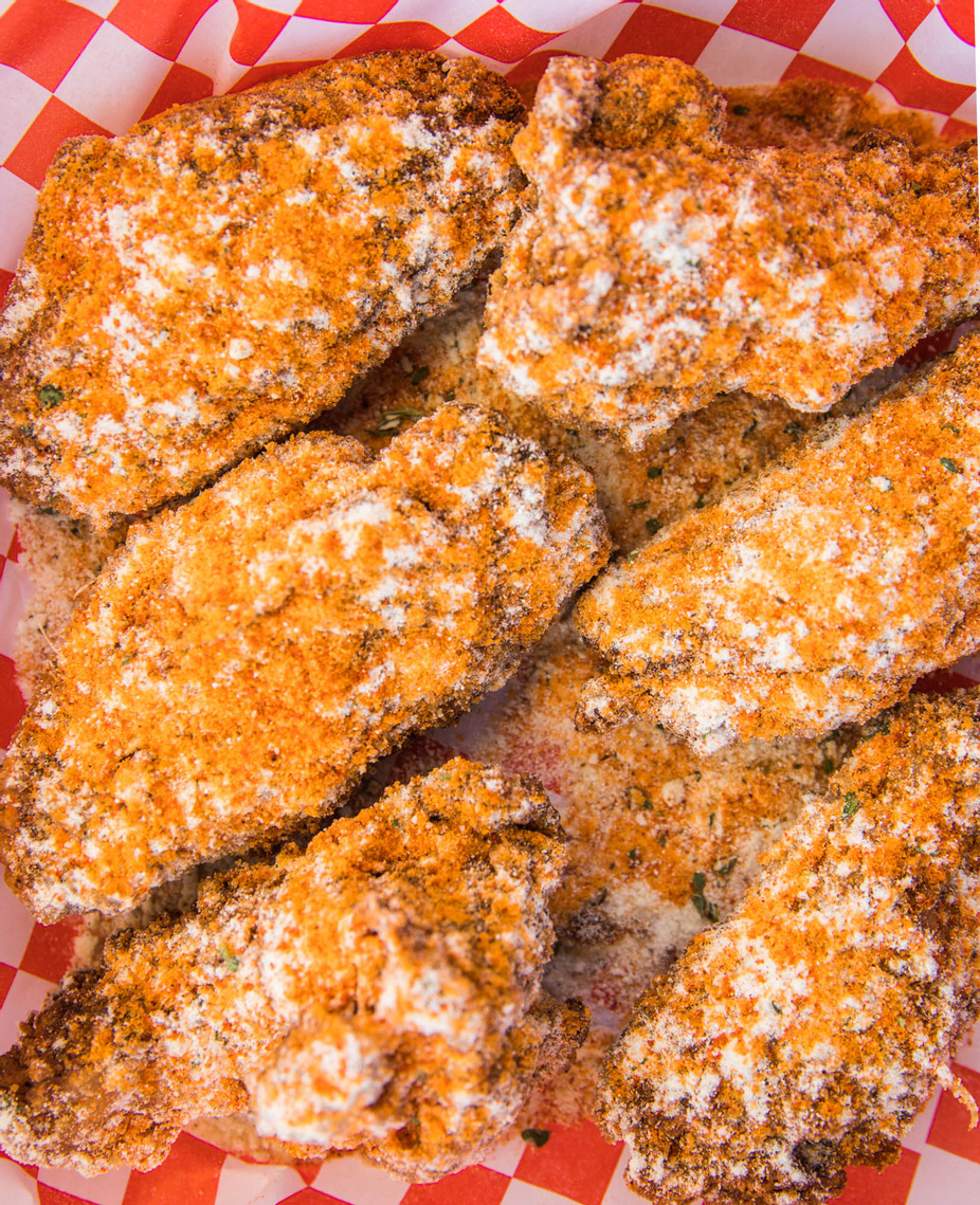 close up of crispy fried chicken wings with seasoned coating Austin food truck