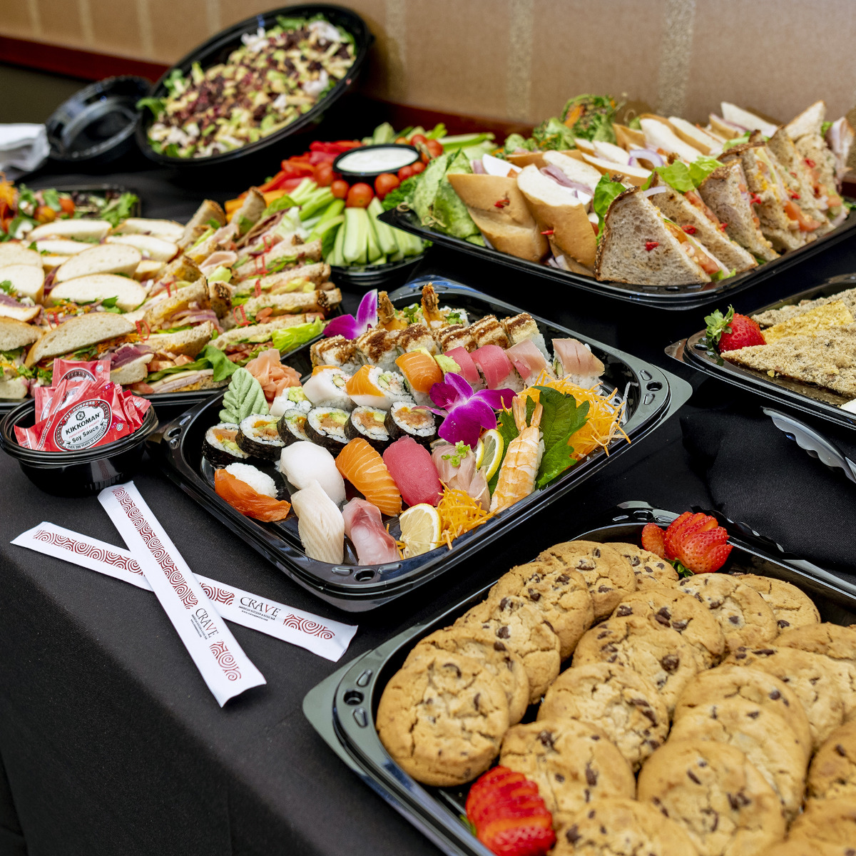 A buffet table filled with a variety of dishes, including salads, meats, and desserts.