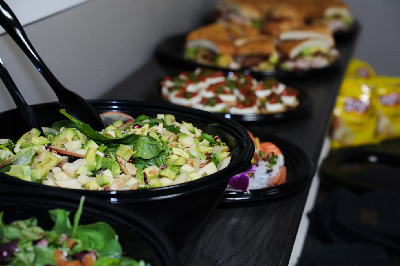 A spread of catered food including salads and platters.