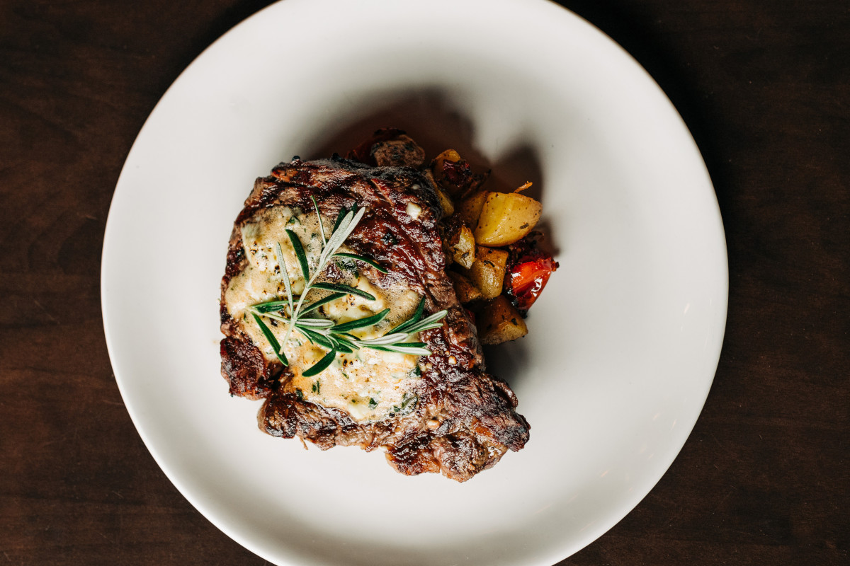 Ribeye steak with chimichurri butter, Yukon gold mash, and broccolini