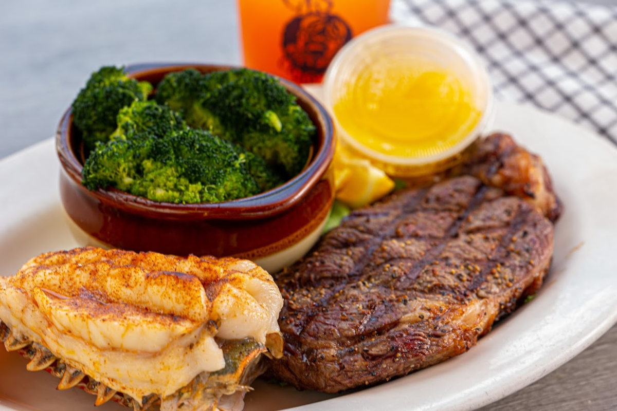 Grilled meat, sandwich, green vegetables and dip on the side