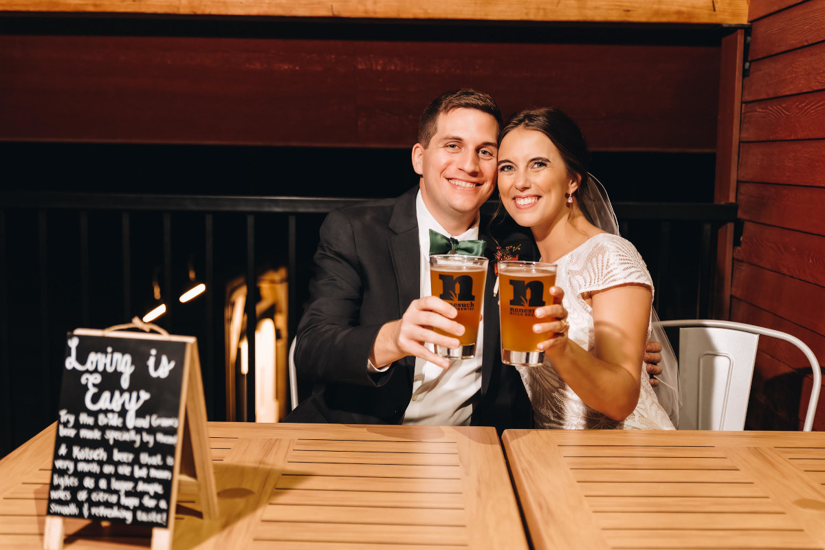 wedding couple holding drinks