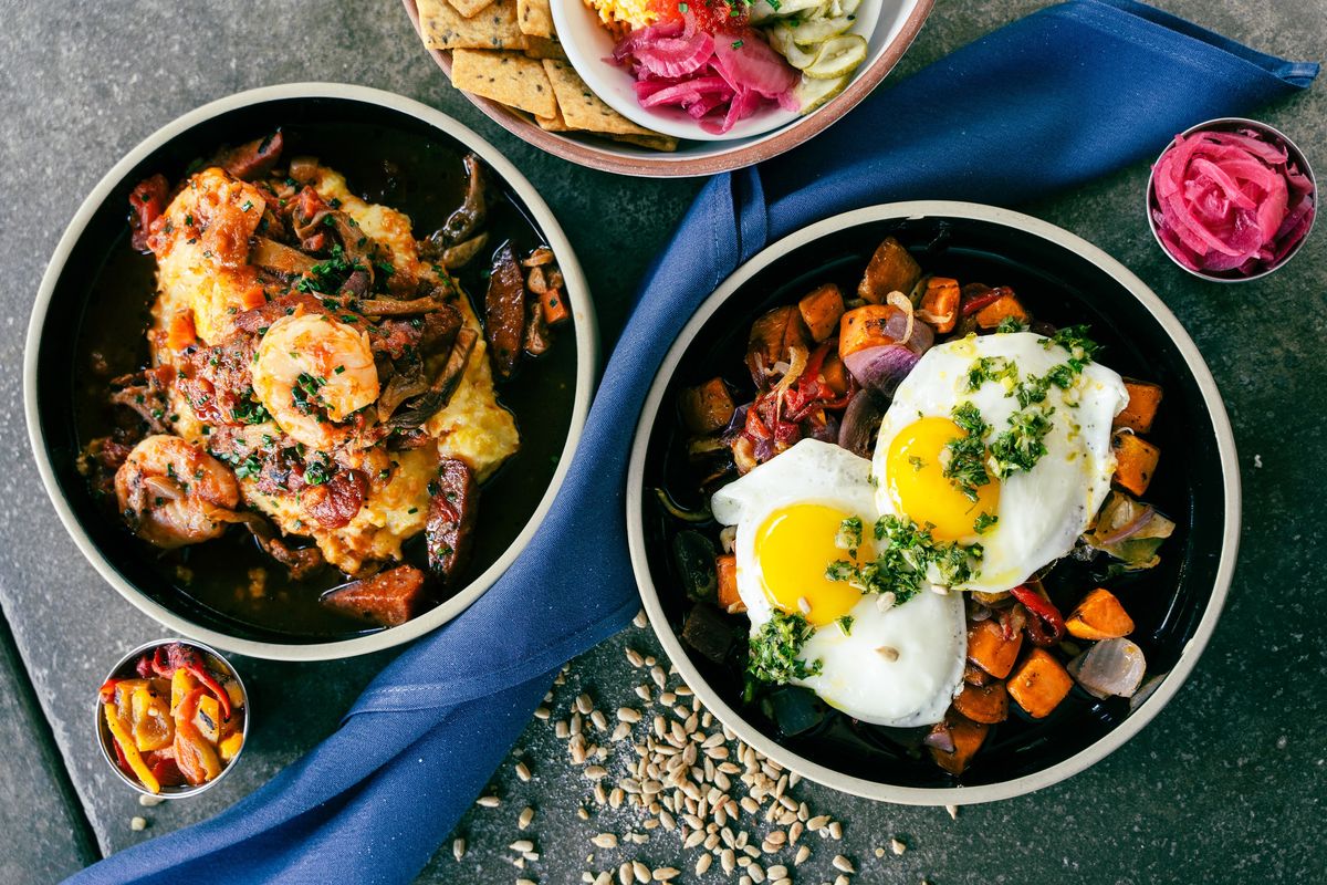 Three bowls of food on a table.