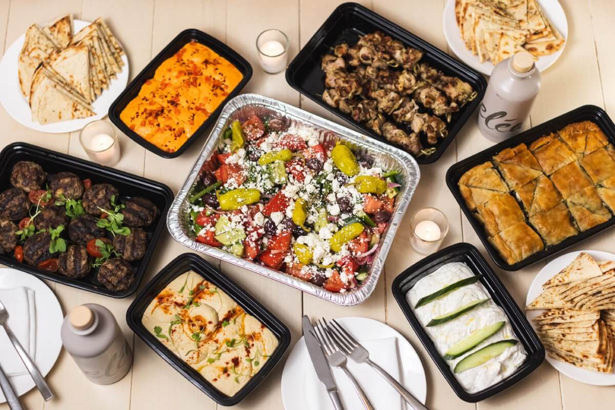 A table set with multiple trays of food