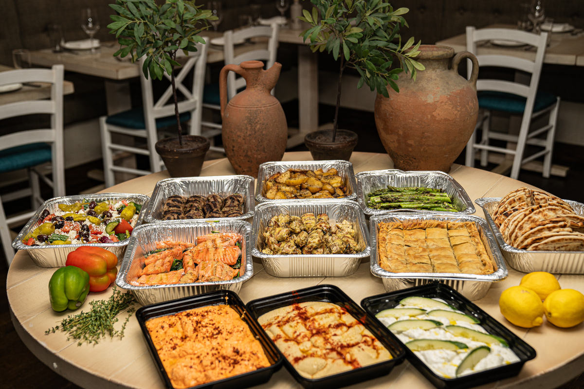 A table set with multiple trays of food