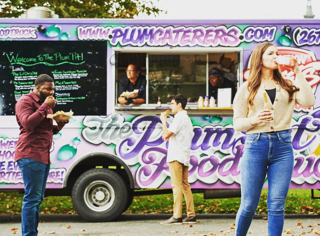 People standing besides the food truck