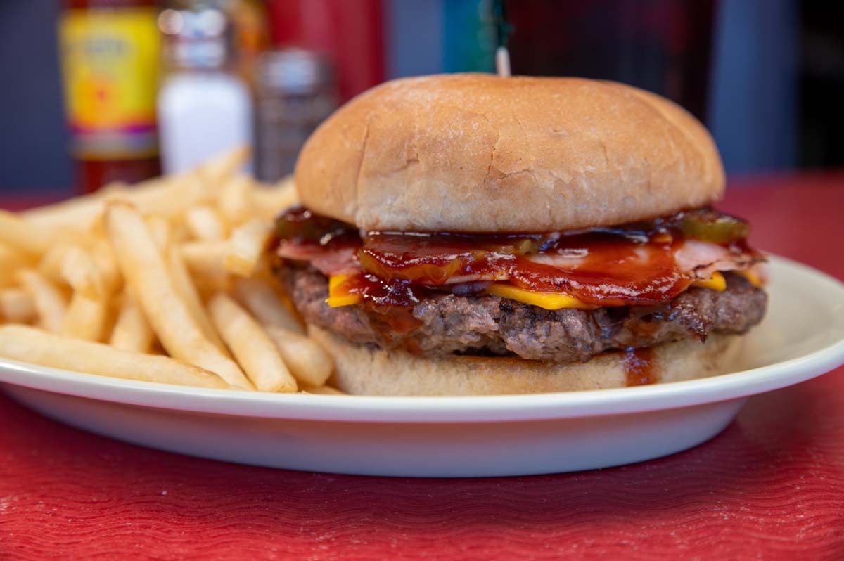 Cheeseburger, with ham, BBQ sauce, and fries