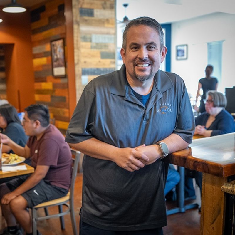 Owner of The Original Cocina Azul in the dining room