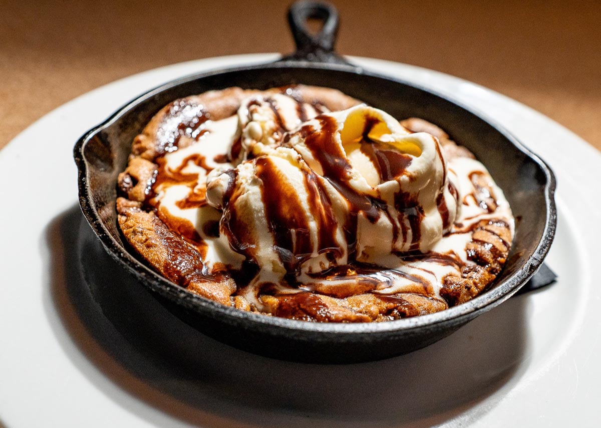 Pancake topped with ice cream and chocolate glaze
