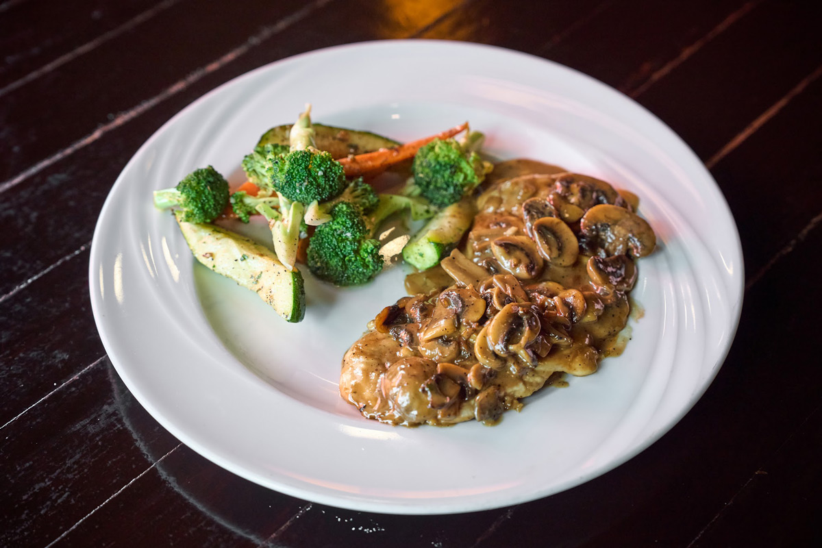 Chicken topped with mushroom sauce, side of veggies