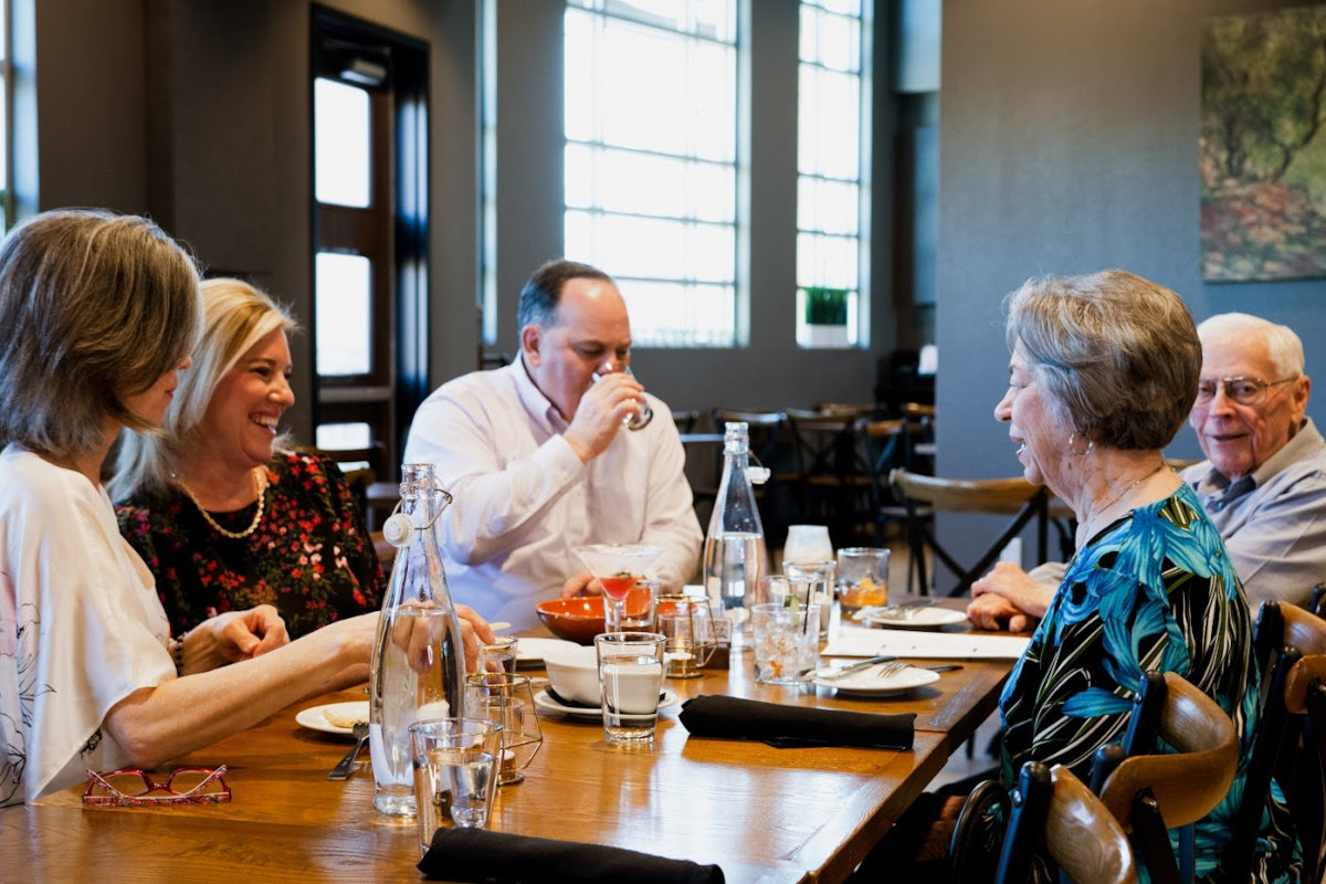 Interior, guests at a table enjoying drinks 