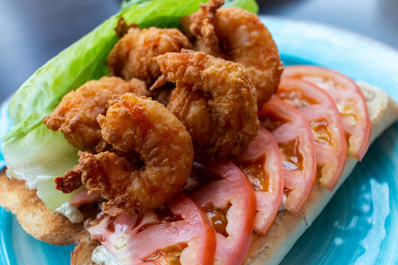 Fried shrimp Po' Boy sandwich, with lettuce, tomato and dressing