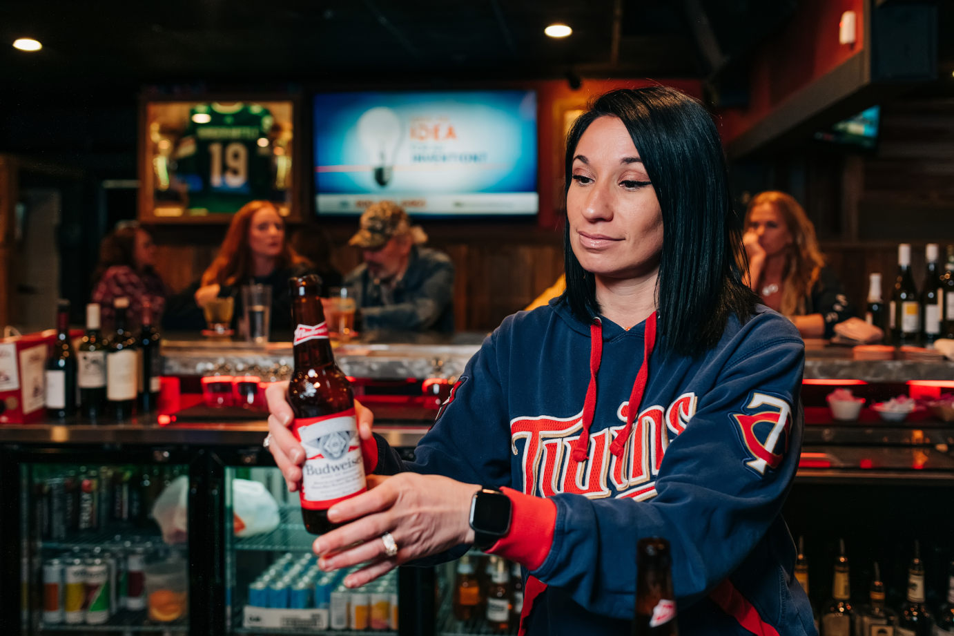 Bartender serving a bottle of beer at the bar