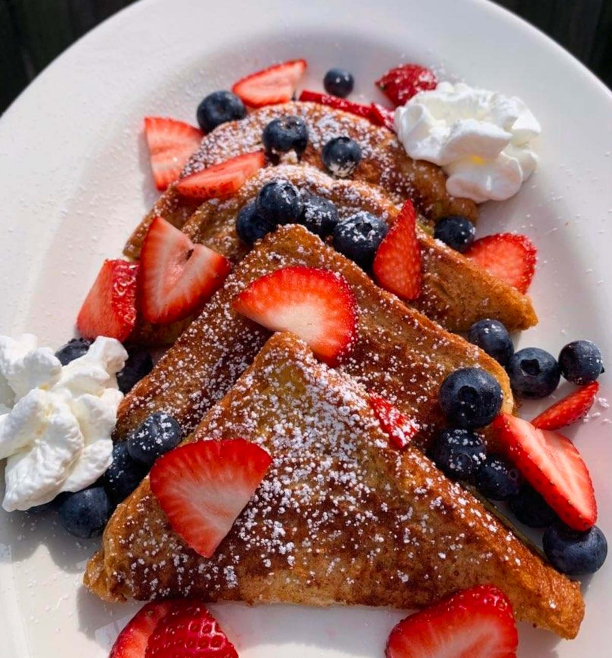 toast garnished with fresh berries, creating a delightful and colorful breakfast presentation