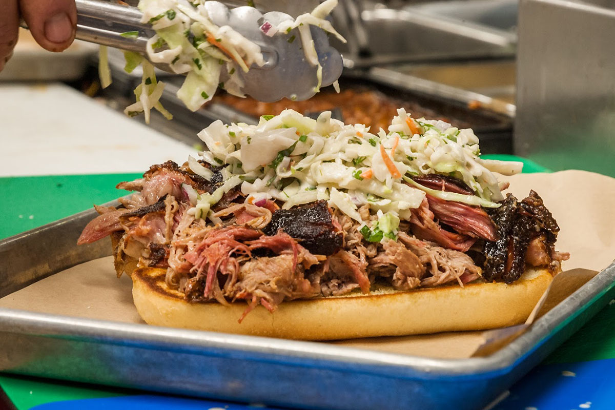 Pulled pork sandwich topped with coleslaw